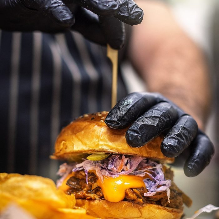food photography of a chef preparing a burger